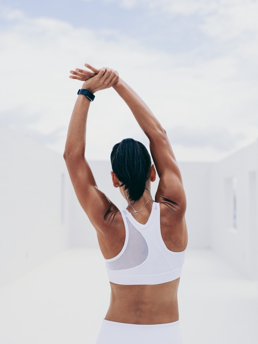 Woman stretching outdoors in natural light, representing the vitality and quality of life that longevity protocols may support