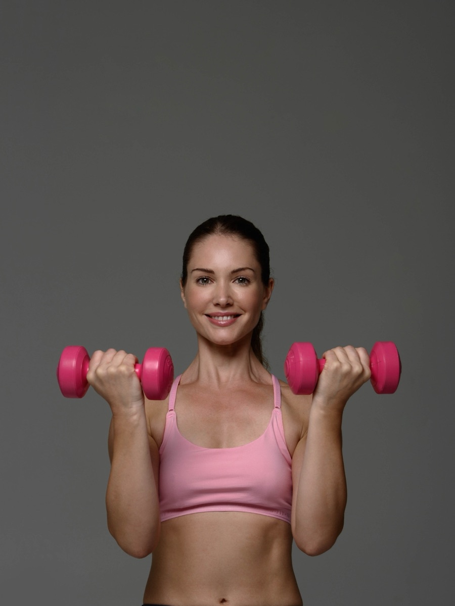 Woman with dumbbells representing sermorelin and strength for women over 40